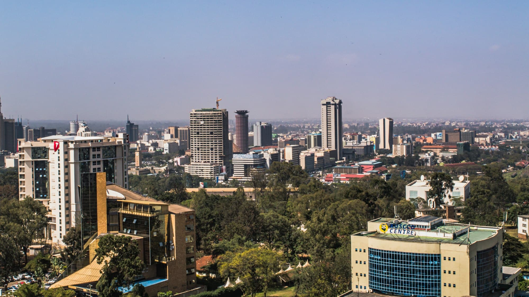 The Nairobi skyline on a clear day, with trees in the foreground