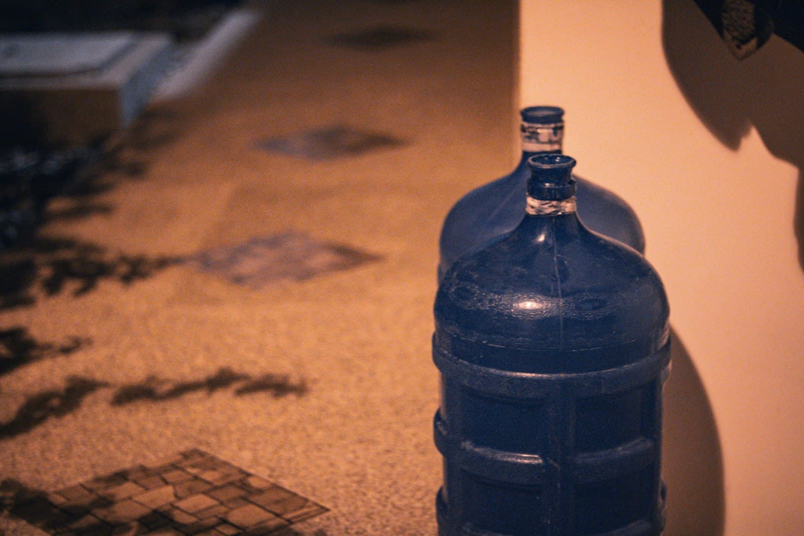 A reusable 20 litre water bottle standing in warm evening light